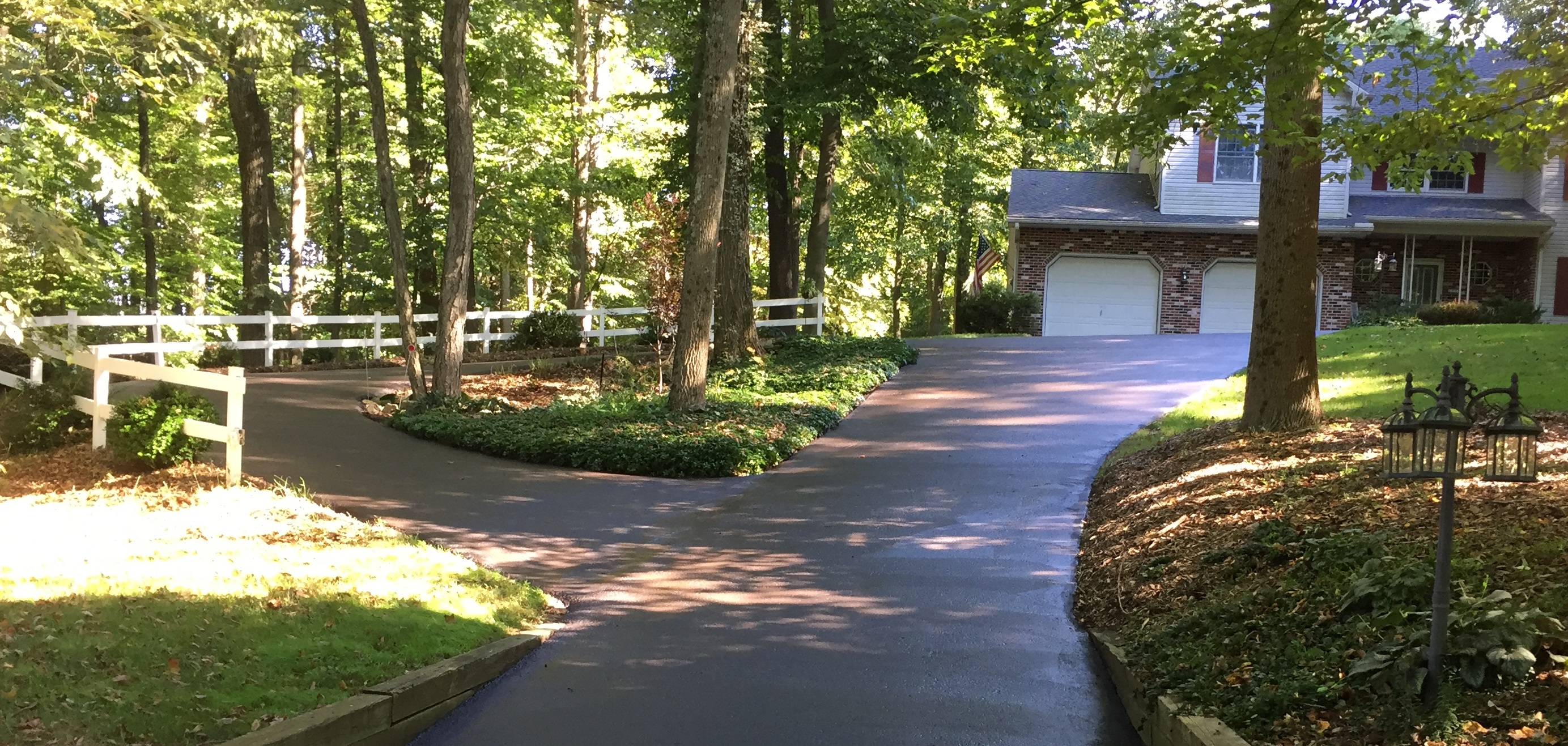 fresh sealcoated driveway. the house location is in a wooded area